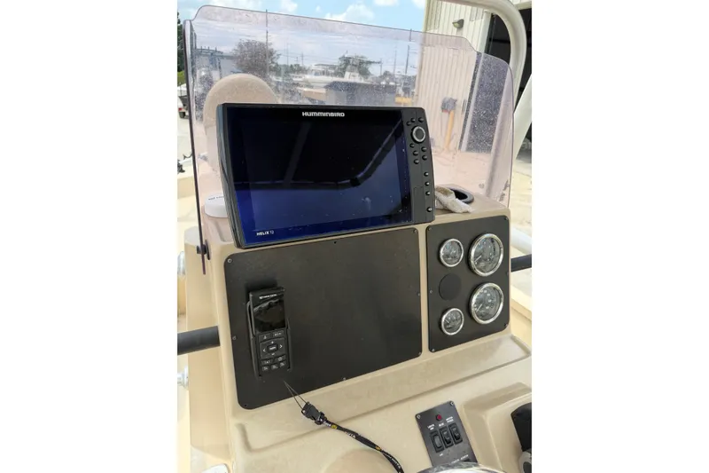 Slide: The Image of 2021 G3 Bay 20 DLX boat dashboard with Humminbird Helix 12 display and gauges. - 9