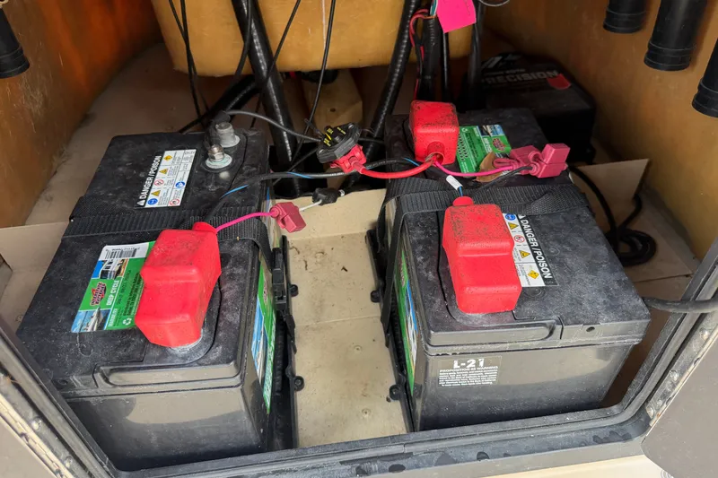 Slide: The Image of Batteries in a 2021 G3 Bay 20 DLX boat, connected with red cables. - 16