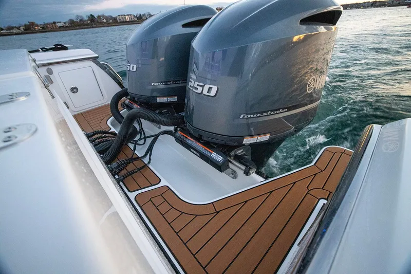 Slide: The Image of Manufacturer Provided Image: 2025 Southport 27 FE boat with twin Yamaha outboard engines on teak deck. - 10