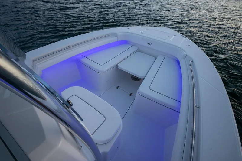 Slide: The Image of Manufacturer Provided Image: 2025 Southport 27 FE boat interior with blue LED lighting on calm water. - 5