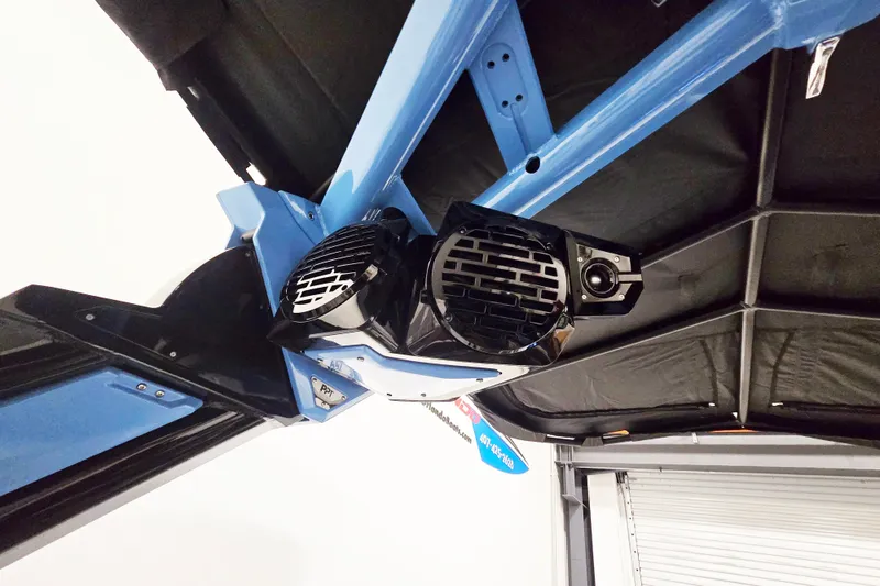 Slide: The Image of 2026 Centurion Ri230 boat speakers mounted on a blue frame, under a black canopy. - 12