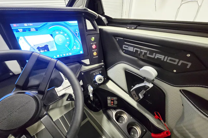 Slide: The Image of Interior of 2026 Centurion Ri230 boat with advanced dashboard and steering wheel. - 9
