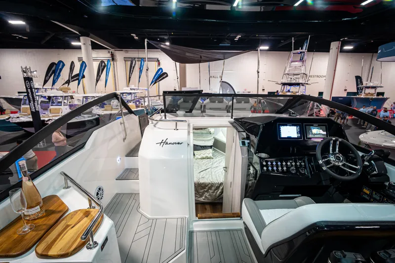 Slide: The Image of Interior view of 2026 Hanover 347 boat at a showroom, featuring modern cockpit and cabin. - 5