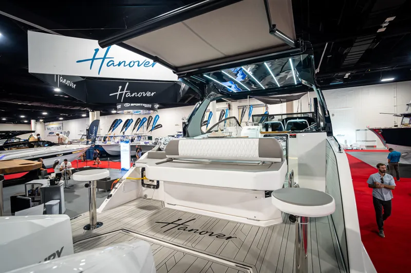 Slide: The Image of 2026 Hanover 347 yacht displayed at a boat show, featuring sleek design and modern amenities. - 2