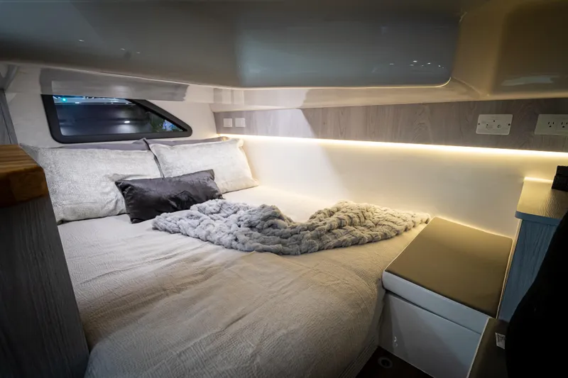 Slide: The Image of Luxurious interior of 2026 Hanover 347 camper with cozy bed and ambient lighting. - 18