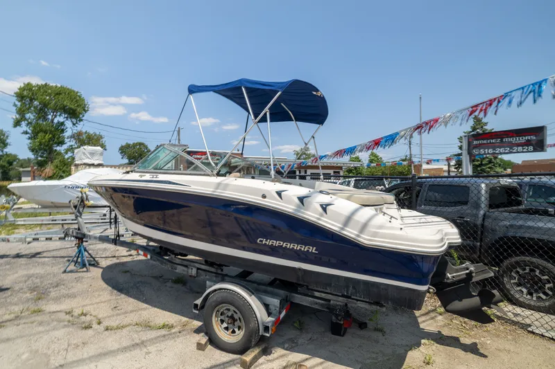 Slide: The Image of 2014 Chaparral 18 H2O Ski & Fish boat on trailer, blue and white, outdoor display. - 2