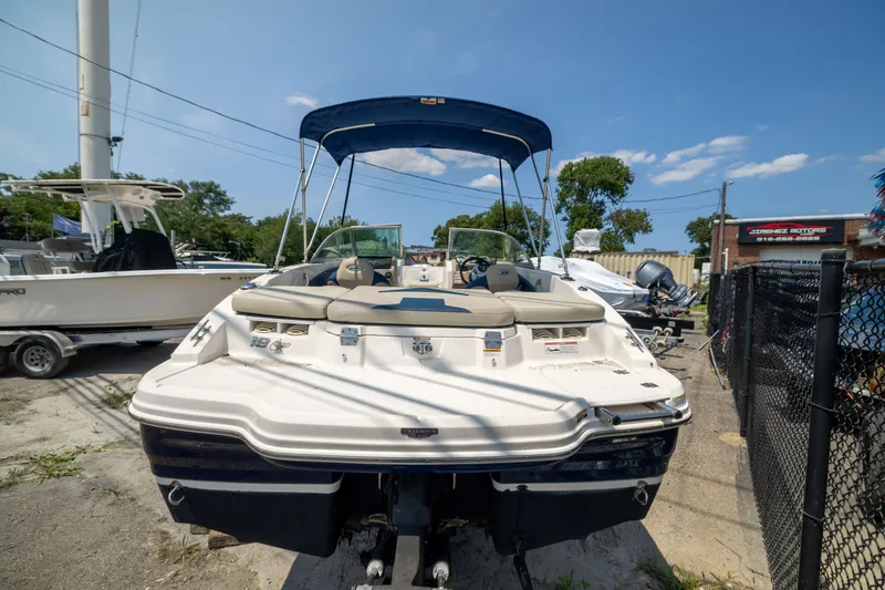 Slide: The Image of 2014 Chaparral 18 H2O Ski & Fish boat with canopy, parked outdoors. - 5