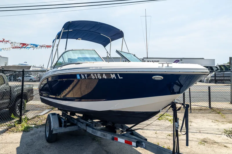 Slide: The Image of 2014 Chaparral 18 H2O Ski & Fish boat on trailer, blue and white exterior. - 4