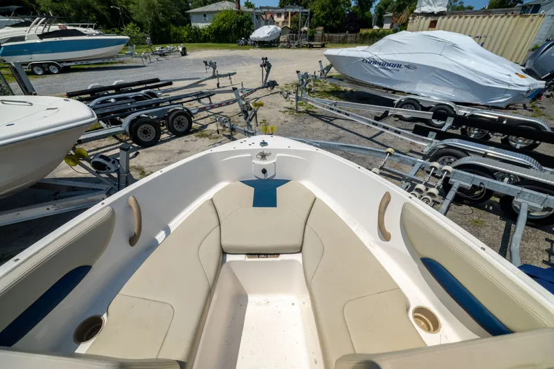 Slide: The Image of 2014 Chaparral 18 H2O Ski & Fish boat interior with trailers in background. - 7