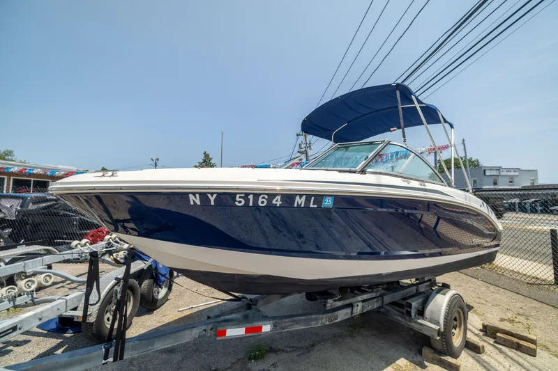 Slide: The Image of 2014 Chaparral 18 H2O Ski & Fish boat on trailer, blue and white design. - 3