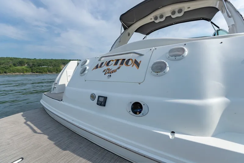 Slide: The Image of 2000 Sea Ray 410 Sundancer yacht docked on a sunny day, featuring sleek design and speakers. - 20