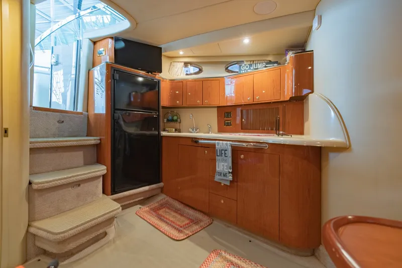 Slide: The Image of Interior of 2000 Sea Ray 410 Sundancer yacht with kitchen and stairs. - 48
