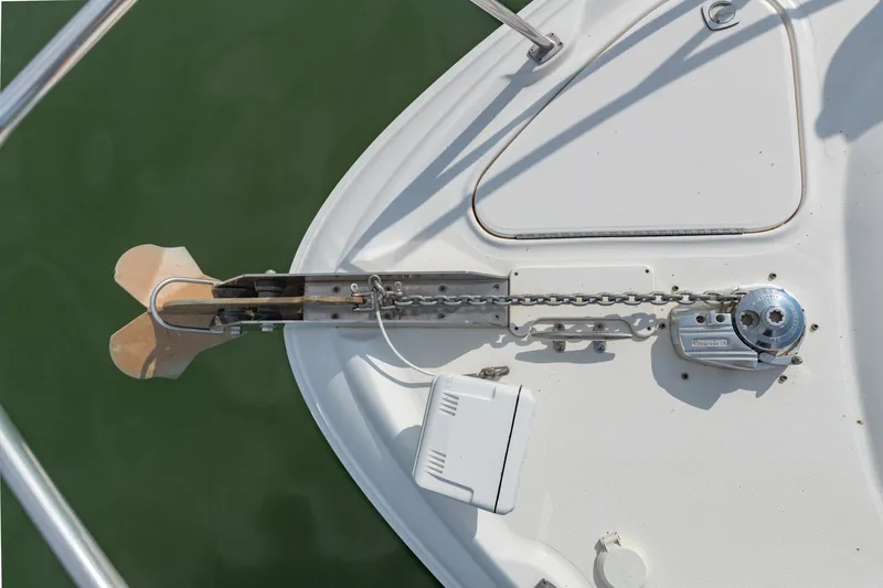 Slide: The Image of Anchor and chain mechanism on a 2000 Sea Ray 410 Sundancer boat deck. - 44