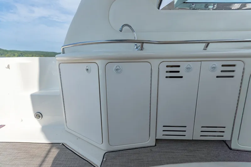 Slide: The Image of Cockpit area of 2000 Sea Ray 410 Sundancer with storage cabinets and sink. - 21