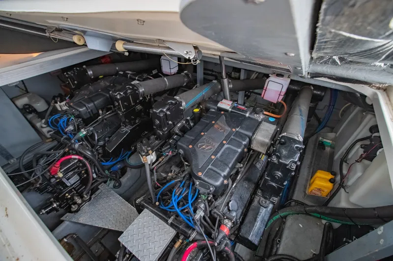 Slide: The Image of Engine room of a 2000 Sea Ray 410 Sundancer, showcasing dual engines and mechanical components. - 61