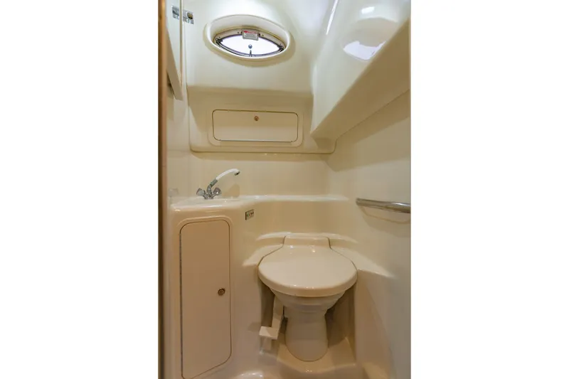 Slide: The Image of Compact bathroom in 2000 Sea Ray 410 Sundancer yacht, featuring toilet and sink. - 46