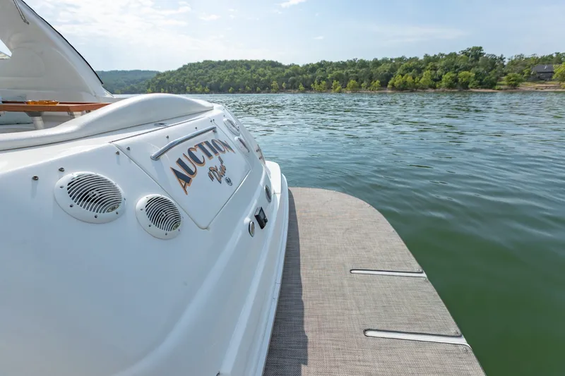 Slide: The Image of 2000 Sea Ray 410 Sundancer yacht on calm lake with scenic forested shoreline. - 18