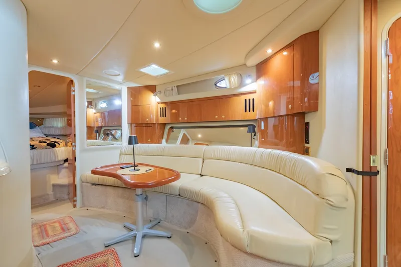 Slide: The Image of Luxurious interior of 2000 Sea Ray 410 Sundancer yacht with plush seating and wooden cabinetry. - 53