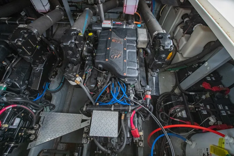 Slide: The Image of Engine compartment of a 2000 Sea Ray 410 Sundancer boat, showcasing mechanical components. - 62