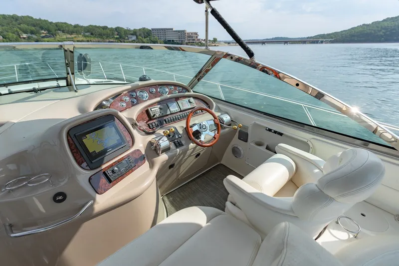 Slide: The Image of Cockpit of 2000 Sea Ray 410 Sundancer yacht with navigation controls and luxurious seating. - 39