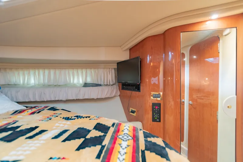 Slide: The Image of Interior cabin of 2000 Sea Ray 410 Sundancer with TV and patterned bedding. - 58