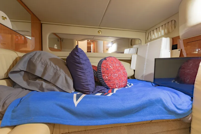Slide: The Image of Interior cabin of 2000 Sea Ray 410 Sundancer with cozy bedding and cushions. - 45