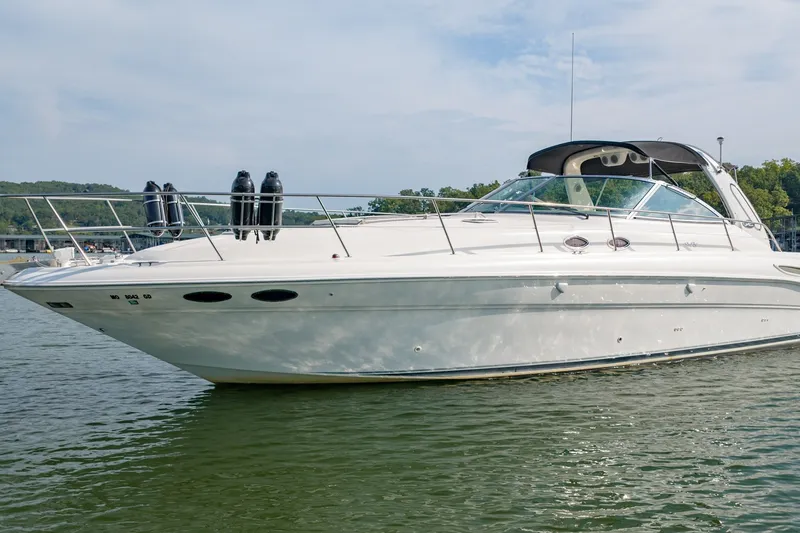 Slide: The Image of 2000 Sea Ray 410 Sundancer yacht on calm water, showcasing sleek design and luxury features. - 6