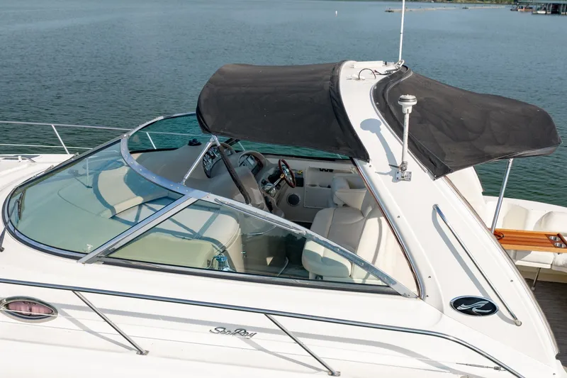 Slide: The Image of 2000 Sea Ray 410 Sundancer yacht with black canopy on calm water. - 13