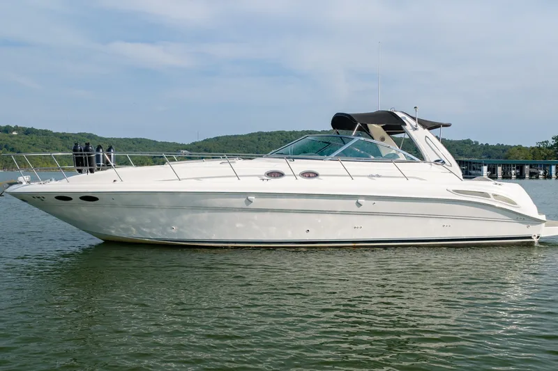 Slide: The Image of 2000 Sea Ray 410 Sundancer yacht on calm water, side view. - 7