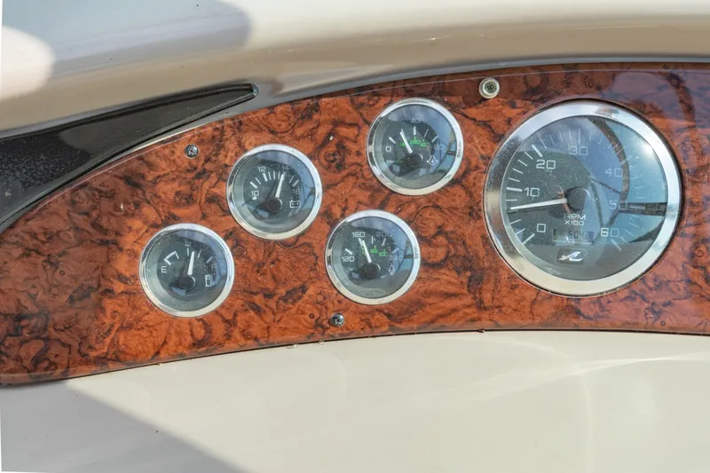 Slide: The Image of Dashboard of a 2000 Sea Ray 410 Sundancer with wood paneling and gauges. - 27