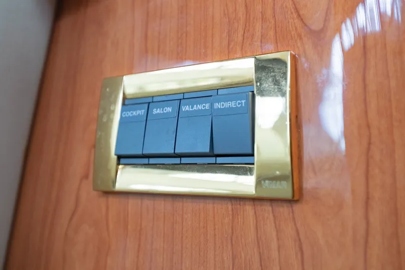 Slide: The Image of Control panel on 2000 Sea Ray 410 Sundancer yacht with labeled switches. - 52
