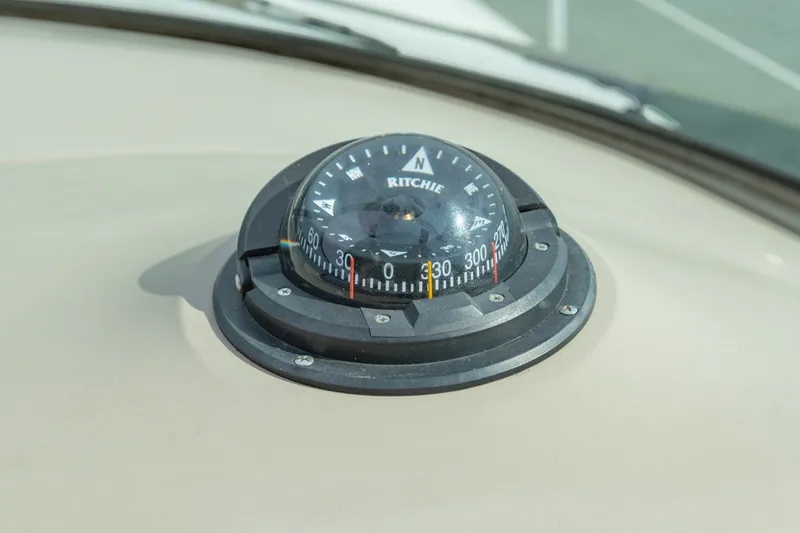 Slide: The Image of Compass on 2000 Sea Ray 410 Sundancer boat dashboard, displaying cardinal directions. - 37