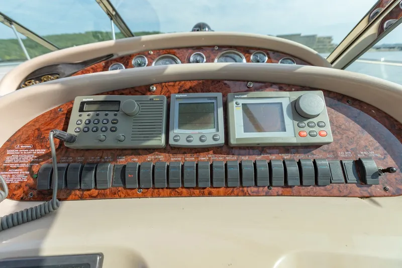 Slide: The Image of Dashboard of a 2000 Sea Ray 410 Sundancer with navigation and communication equipment. - 31