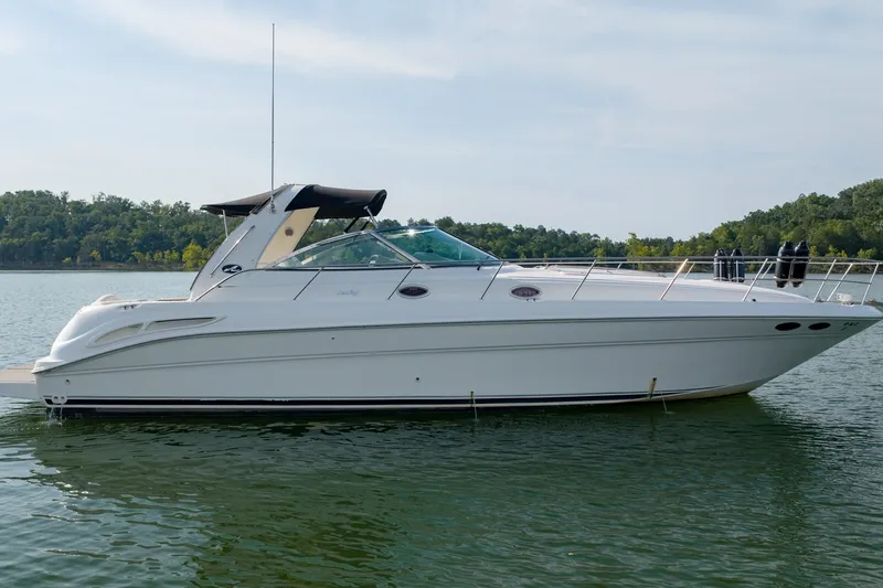 Slide: The Image of 2000 Sea Ray 410 Sundancer yacht on calm water, side view. - 2