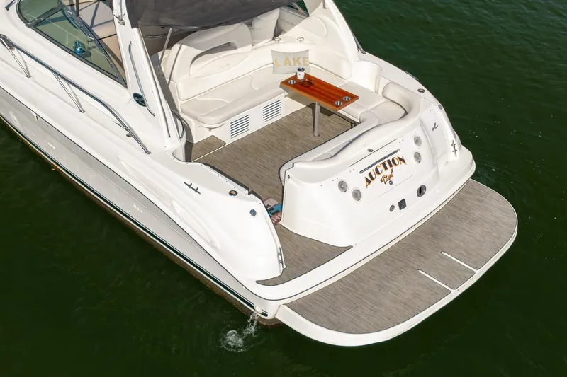 Slide: The Image of 2000 Sea Ray 410 Sundancer yacht with spacious deck and seating on calm water. - 14