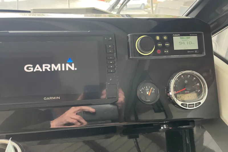 Slide: The Image of Dashboard of 2022 Jeanneau NC Weekender 695 Series 2 with Garmin and Fusion systems. - 9