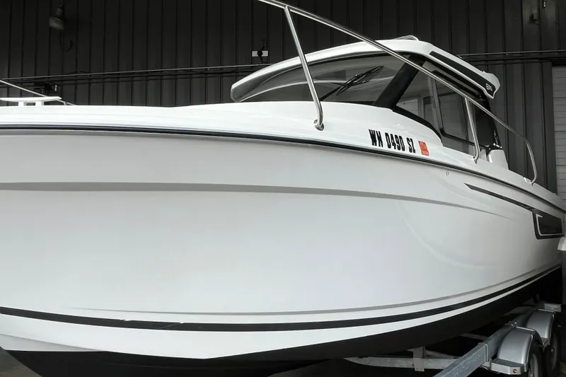 Slide: The Image of 2022 Jeanneau NC Weekender 695 Series 2 boat in a showroom setting. - 13