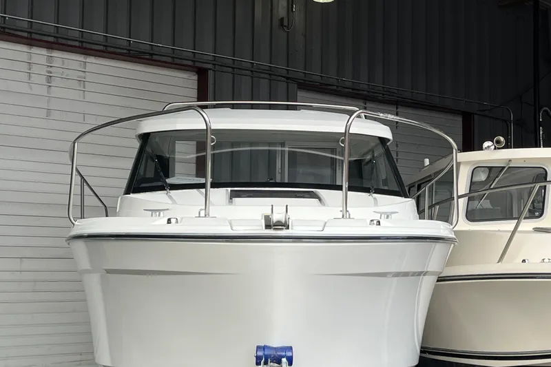 Slide: The Image of 2022 Jeanneau NC Weekender 695 Series 2 boat in storage, front view. - 11