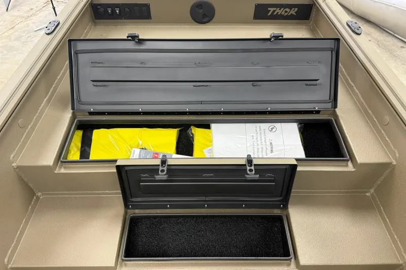 Slide: The Image of Open storage compartments in a 2027 Thor 1754 Thunder Hammer boat. - 14