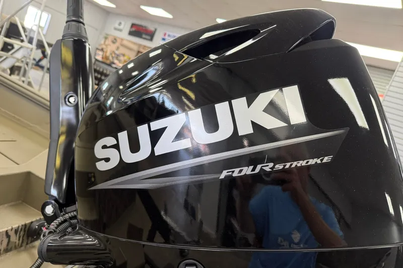 Slide: The Image of Black Suzuki Four Stroke engine in showroom, reflecting surroundings. - 9