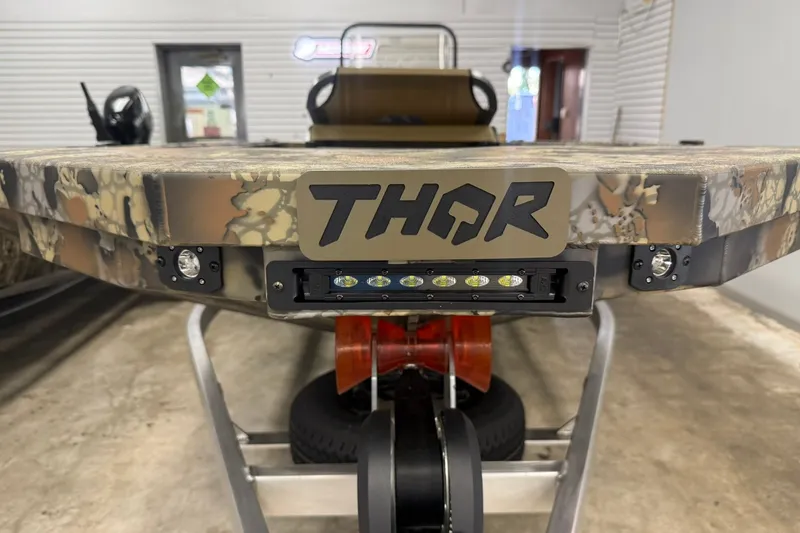 Slide: The Image of Front view of 2027 Thor 1754 Thunder Hammer boat with camouflage design. - 17