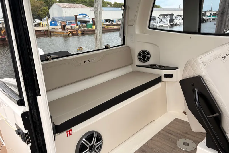 Slide: The Image of Interior of 2026 Navan C30 boat with seating, cup holders, and speakers by the dock. - 15