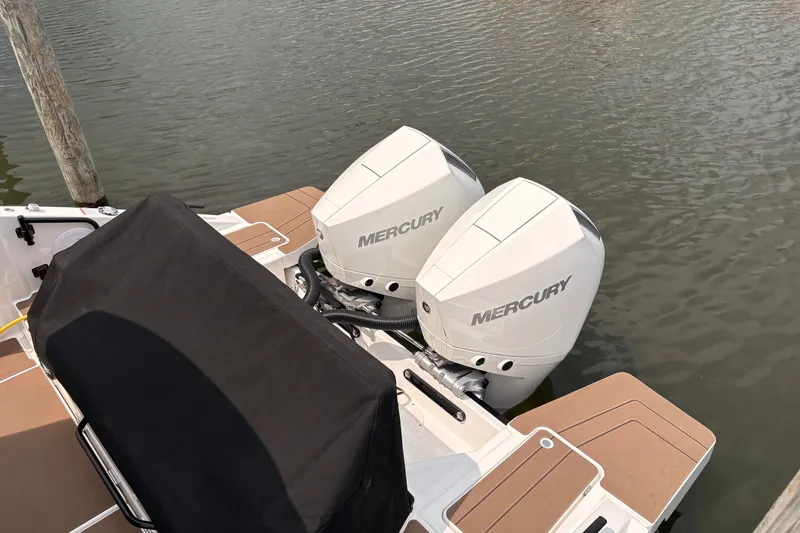 Slide: The Image of Twin Mercury outboard engines on a 2026 Navan C30 boat, docked by the water. - 12