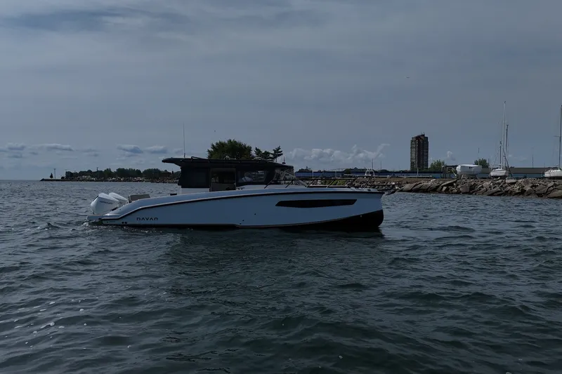 Slide: The Image of 2026 Navan C30 boat cruising on a calm waterfront with cityscape background. - 8