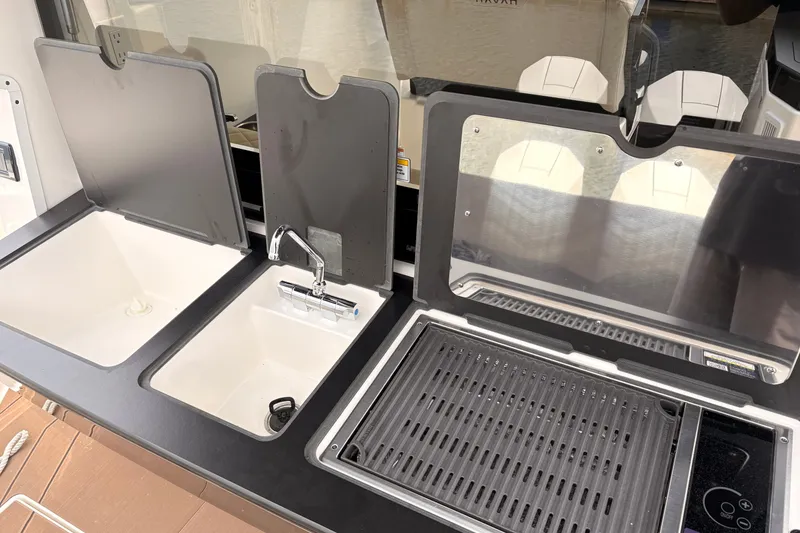 Slide: The Image of Modern kitchen setup in 2026 Navan C30, featuring dual sinks and a grill. - 13