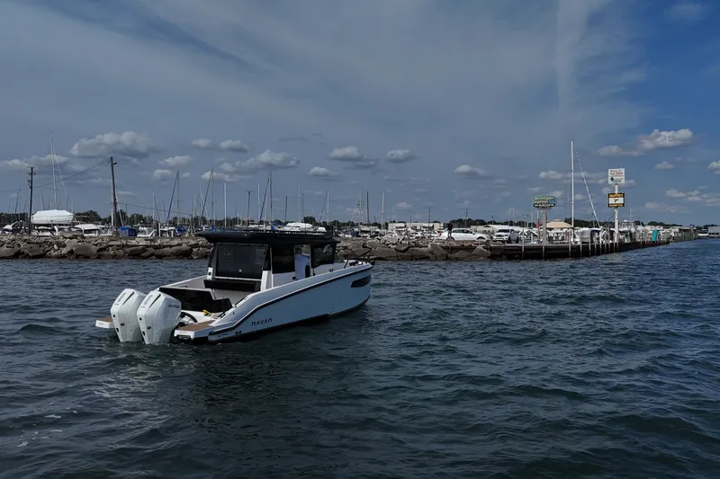 Slide: The Image of 2026 Navan C30 boat on water near marina with cloudy sky. - 4