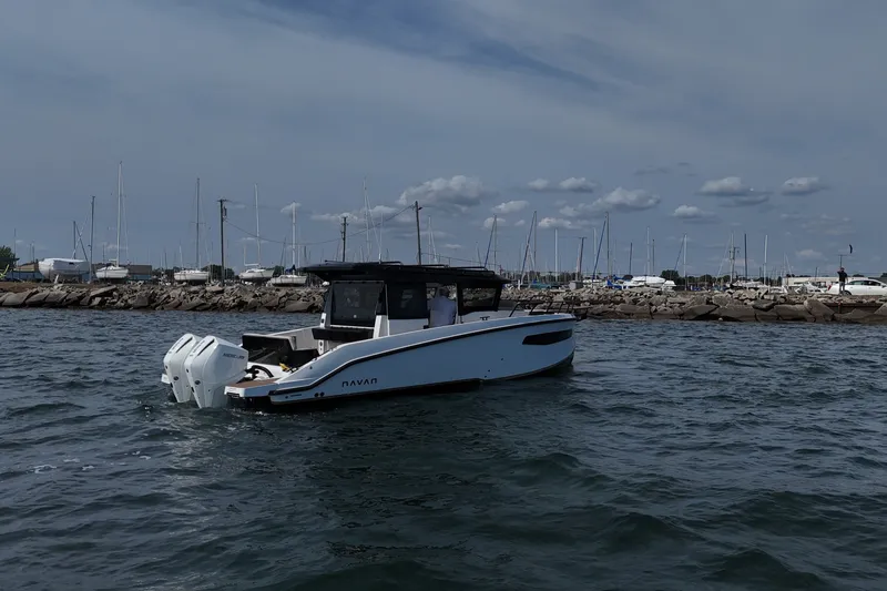 Slide: The Image of Navan C30 2026 boat cruising near marina with sailboats and cloudy sky. - 6