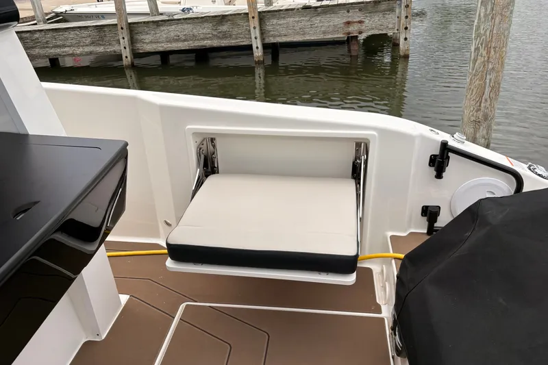 Slide: The Image of Foldable seat on Navan C30 boat, 2026 model, docked by wooden pier. - 14