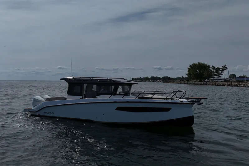 Slide: The Image of 2026 Navan C30 boat cruising on a calm lake under a cloudy sky. - 9