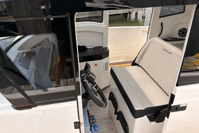 Slide: The Image of Interior of 2026 Navan C30 boat with steering wheel and seating area. - 11
